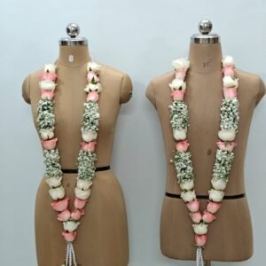 Wedding flower garland with pink and white roses, white filler flowers and pearl detailing on mannequins